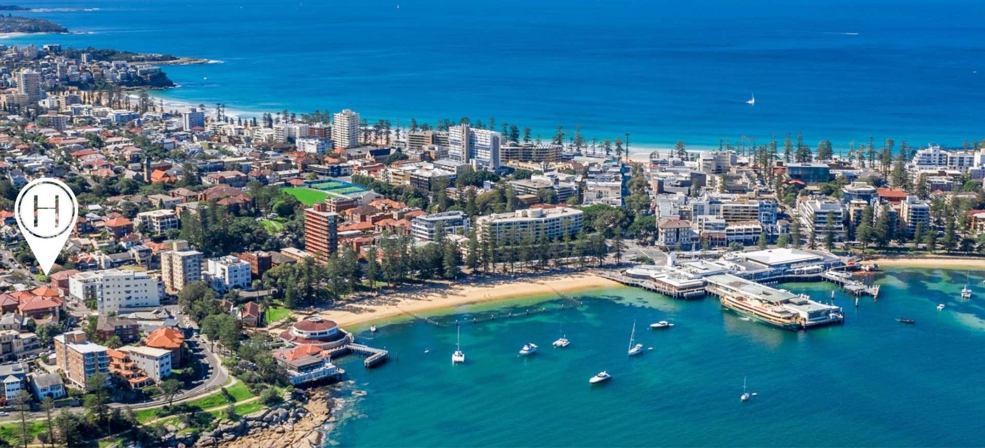 Aerial view of Manly harbour and beach showing The Henry location marker