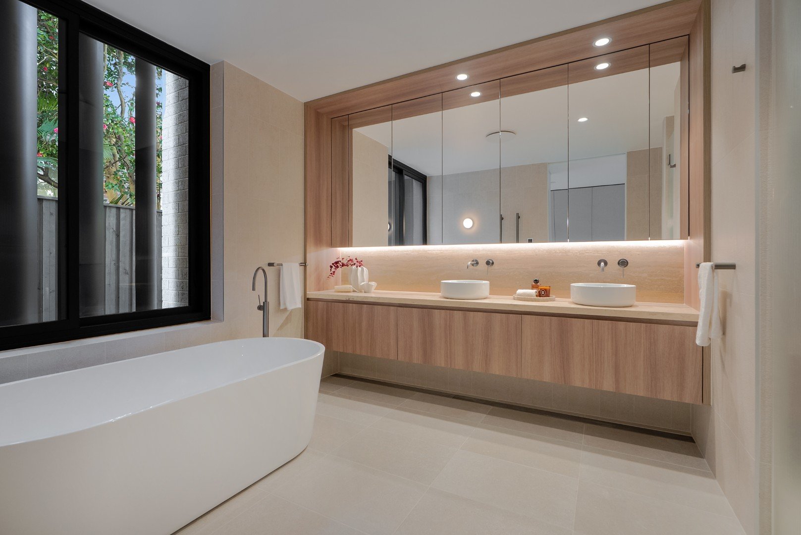 The Henry Manly bathroom with Travertine stone, freestanding bath and heated towel rails